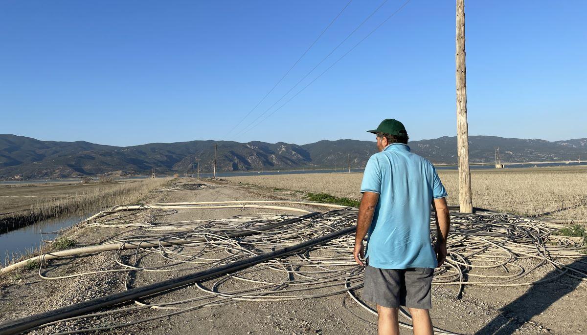 Farmer Achilleas Gerotolios looks out at the flooded Lake Karla near Sotirio, Larissa, Greece. July 29 2024. Thomson Reuters Foundation/Beatrice Tridimas