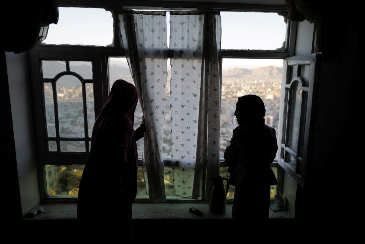 Girls look out from a window in their house at Tv mountain in Kabul, Afghanistan October 15, 2021. REUTERS/Zohra Bensemra